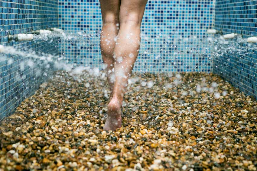 Individual walking on pebbled flooring