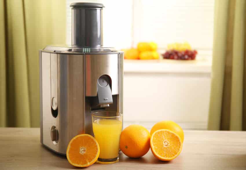 Juicer type of appliance on wood countertop