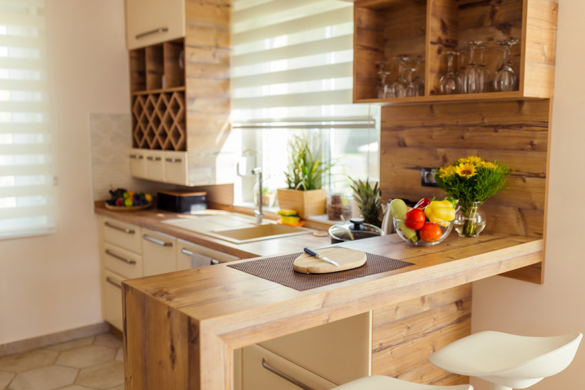 Kitchen counter with heat protection mat, window, drawers, cabinets, and sink