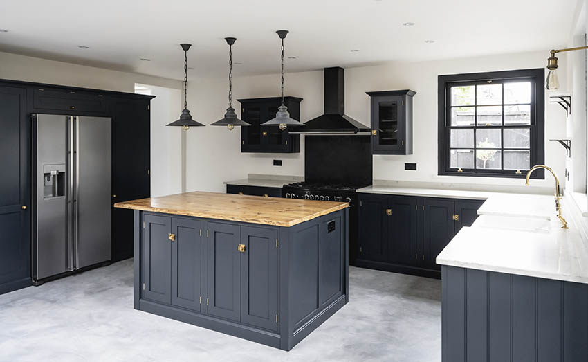 Kitchen with black cabinets white quartz countertops butcher block countertop island