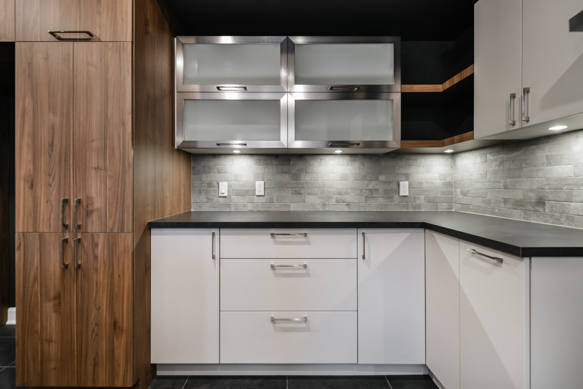 Kitchen with two tone cabinets and granite tile backsplash