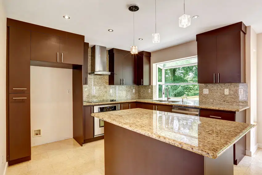 Kitchen with center island, granite backsplash, countertops, cabinets, and windows