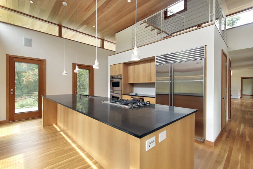 Kitchen with prep island with stovetop and matte black surface