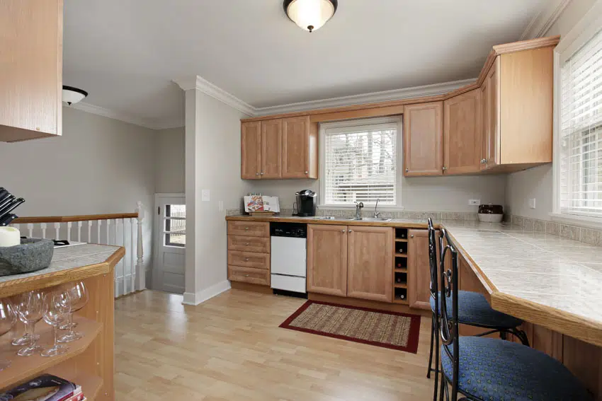 Kitchen with dining area, pickled oak cabinets, wood floor, and window