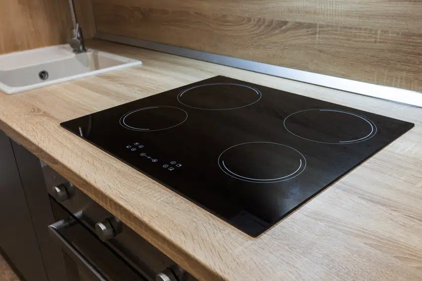 Induction cooktop on wood kitchen countertop