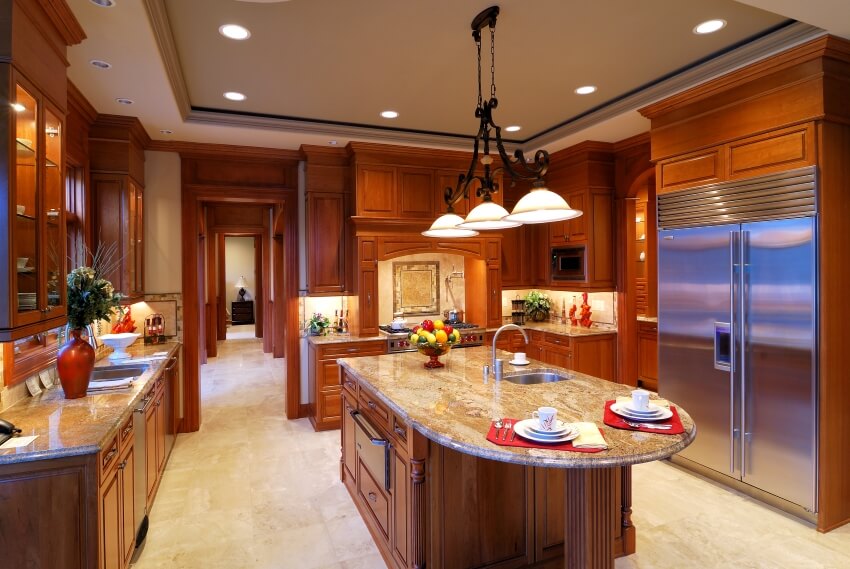Large kitchen with marble tile floor, cherry wood cabinets, island, and overhead lighting