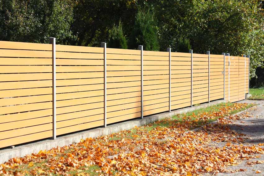 Light wood composite fencing next to street