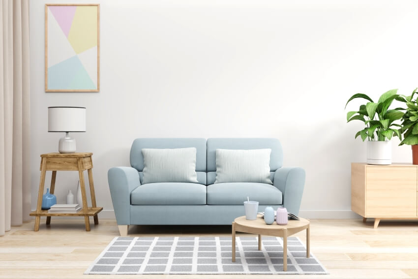 Room with blue sofa, plant, carpet and lamp shade