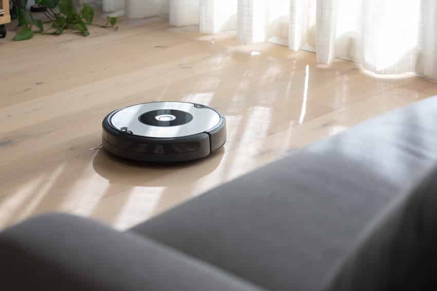 Living room with couch, and robot vacuum