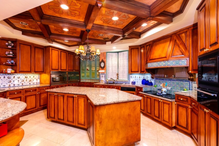 Luxury home kitchen with red cherry wood cabinets, granite countertops, and coffered ceiling