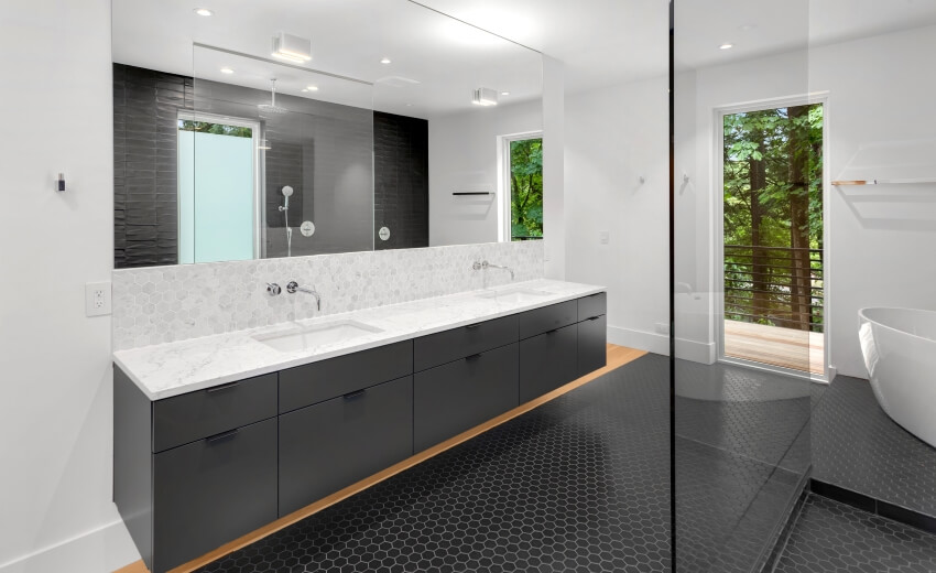 Modern bathroom interior with honeycomb tile floor, and floating double vanity with marble countertop
