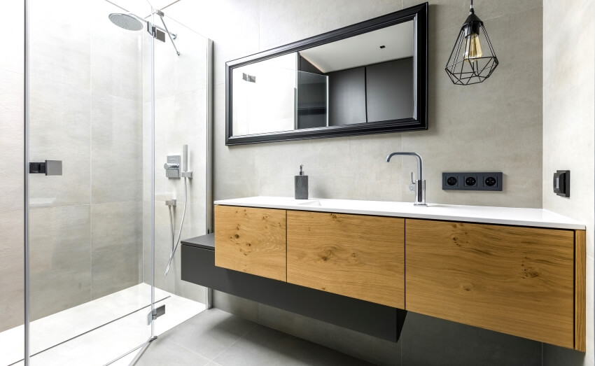 Modern bathroom with rain shower, glass enclosure and floating wood vanity