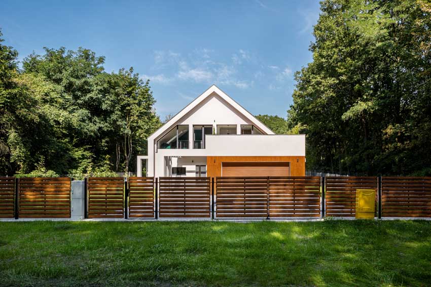 Modern house exterior with garage, and composite fencing