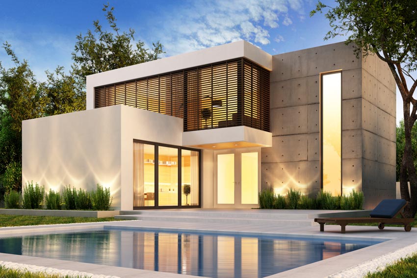 Modern house exterior with landscape lighting, pool, and glass door
