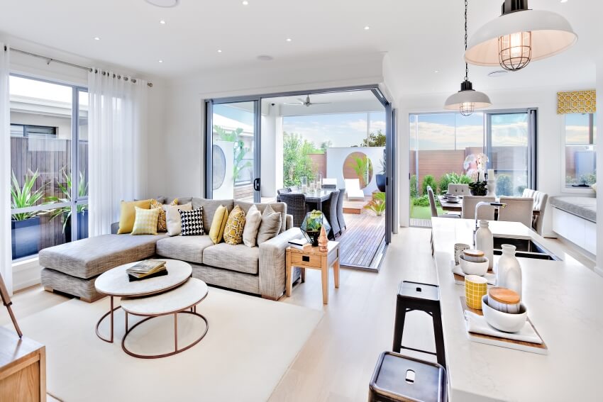 Modern kitchen attached to the living area beside a patio with sectional sofa