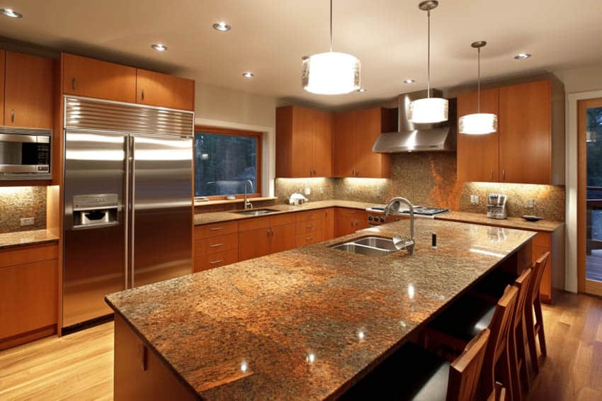 Modern kitchen with brown granite countertops tan painted walls
