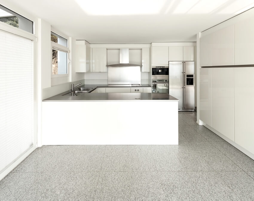 Modern kitchen with white cabinets, and floors of sand cushion terrazzo 