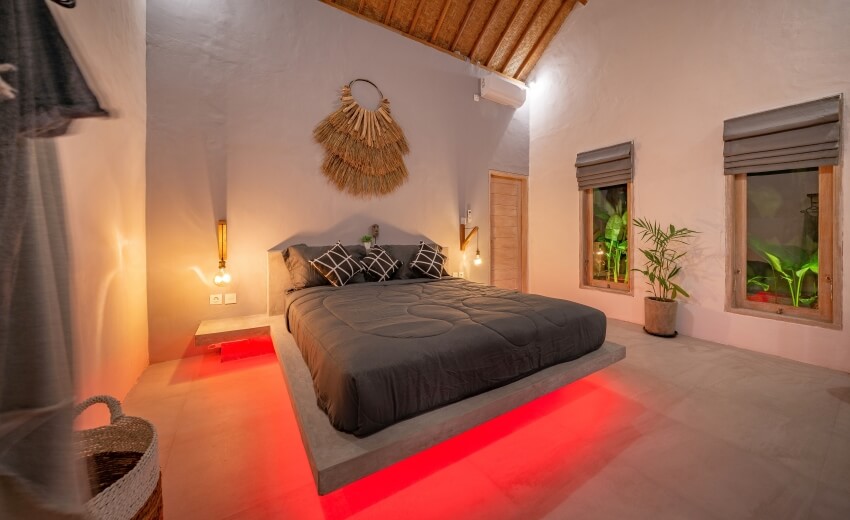 Modern stone pine bed with red mood LED lighting, wall lamps, and vaulted ceiling