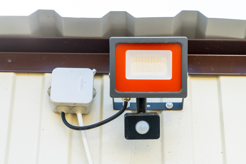 Motion sensor LED light near metal roof
