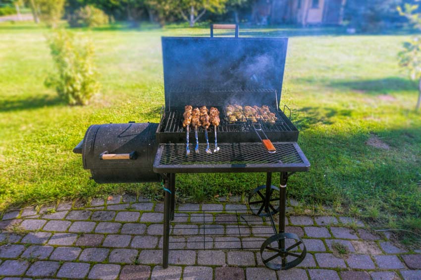Outdoor area with pros and cons of pellet grills, and grassy field
