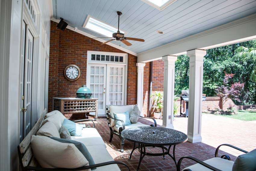 Outdoor patio with brick wall and skylight 