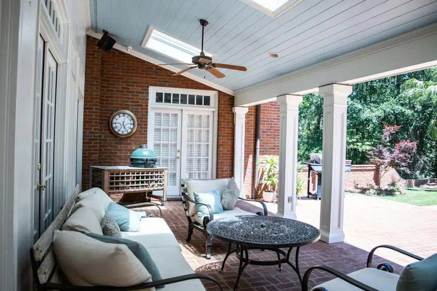 Patio with brick wall, skylight, clock and couch