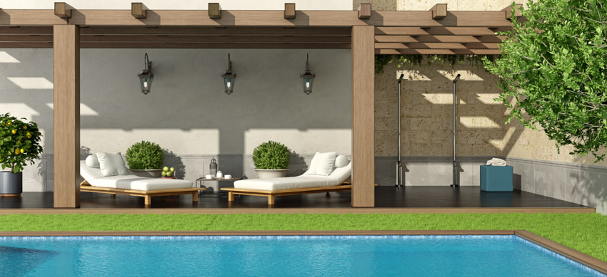 Outdoor pool with lounge chairs, pergola, and shower area