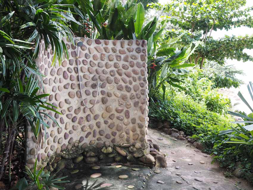 Curved area with hand shower and plants