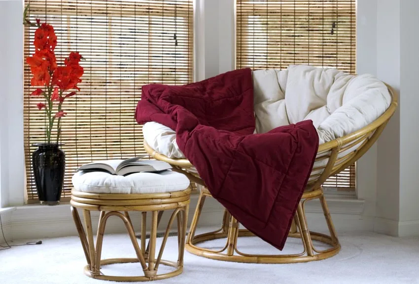 Papasan chair with cushion, small round table, and decoration