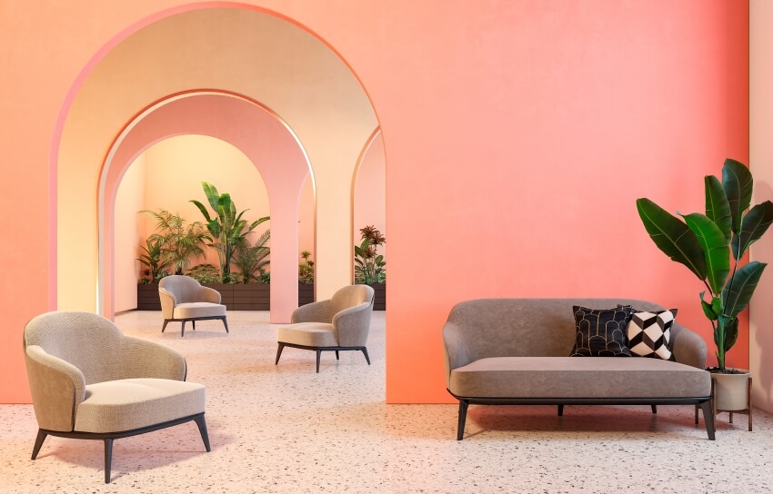 Pink interior with arches, sofa, armchairs, terrazzo floor, and plants