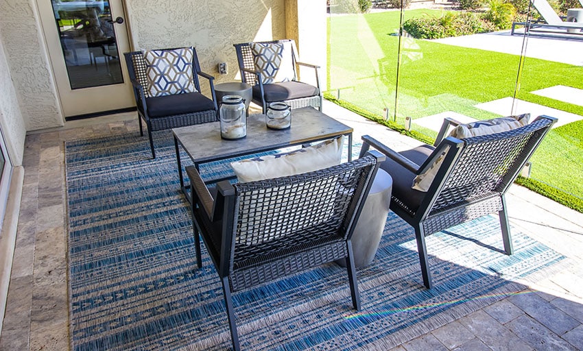 Porch with rattan chairs coffee table outdoor rug