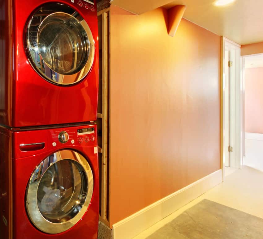 Red stackable washer dryer in laundry area