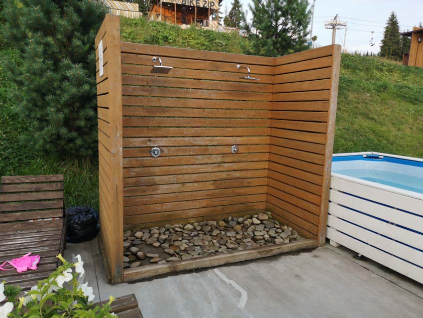 Wooden enclosure with stone platform for double showers