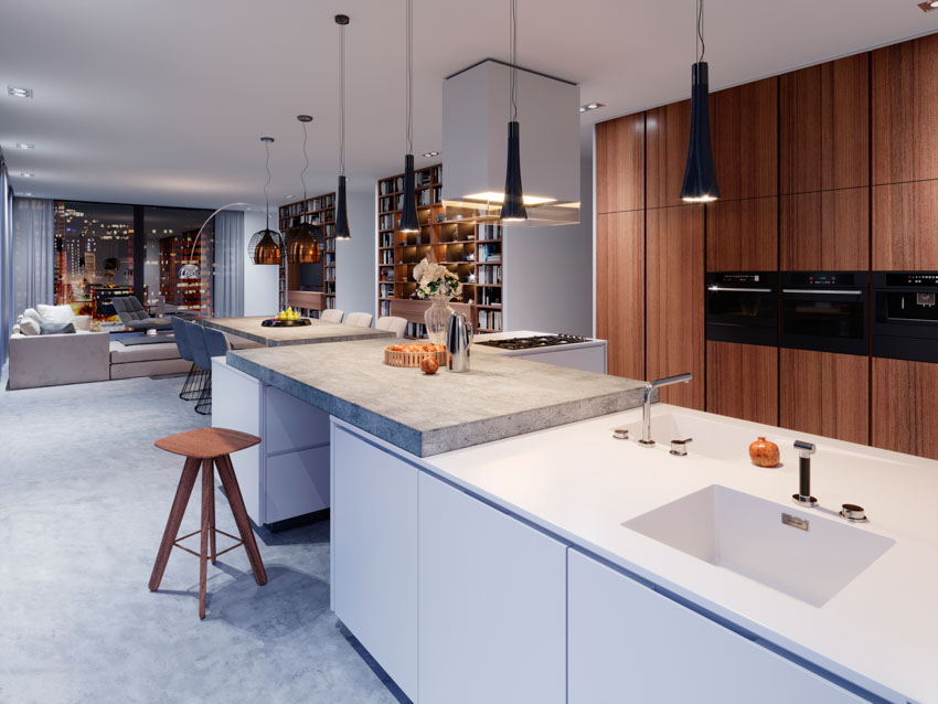 Spacious kitchen with floating stone countertop, center island, wood cabinets, and hanging lights