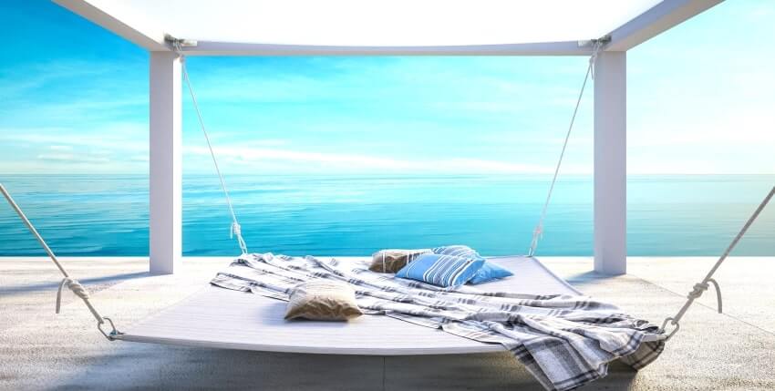 Square hammock with pillows, blanket, and beautiful view of the ocean