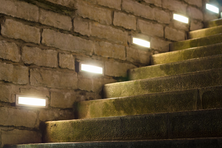 Step lights installed on brick wall