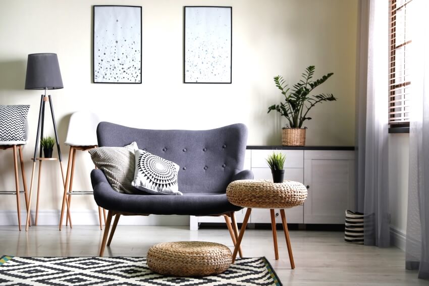 Stylish room with modern settee, and floor lamp in between bar chairs