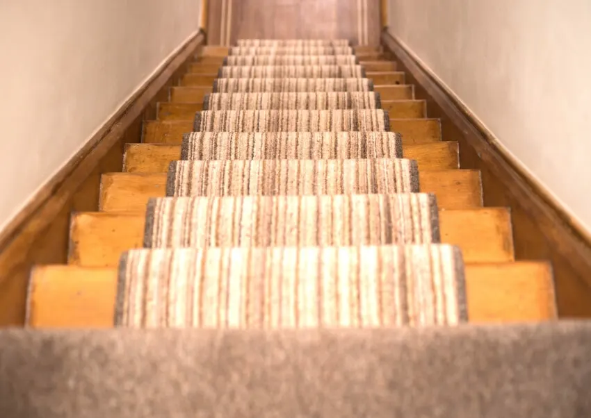 Wooden stairs with patterned runner