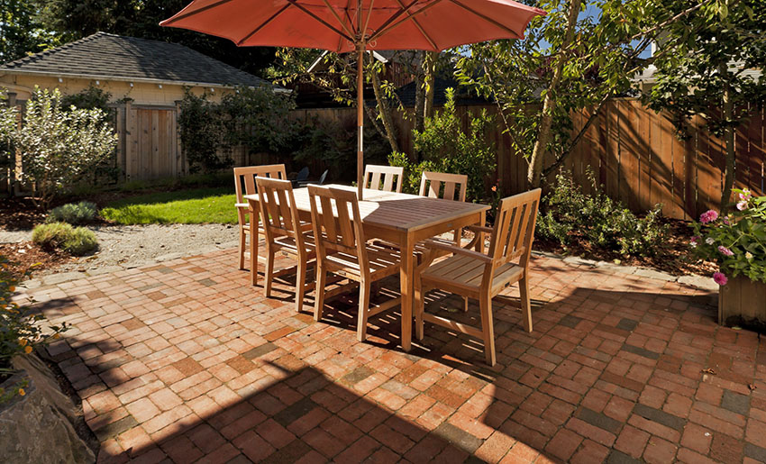 Brick paver patio with wood outdoor dining table