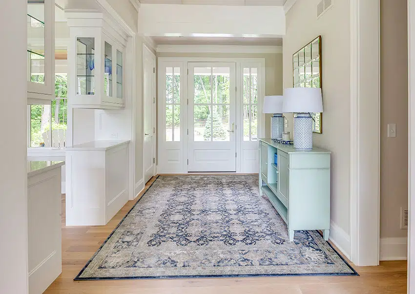 Entryway with console table and table lampshades runner rug French doors