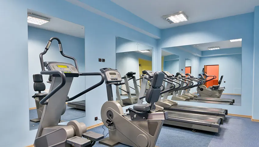 Gym with blue painted walls and mirrors