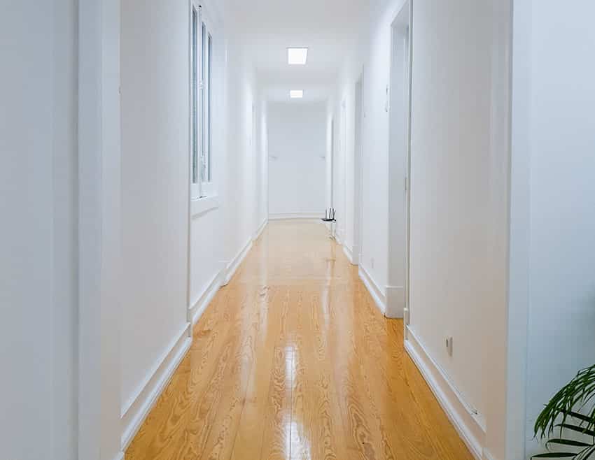 Hallway with wood flooring white paint
