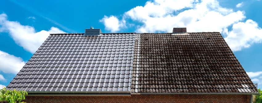 A half cleaned house roof shows the before and after effect of a roof cleaning