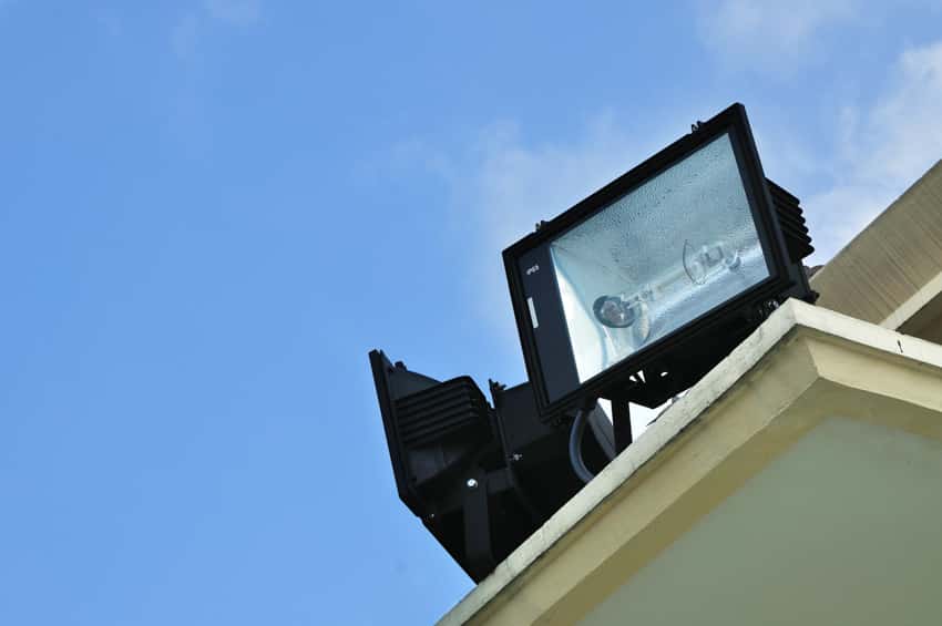 Pair of black flood-style lights on top of a ledge