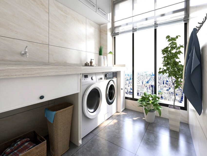 Apartment laundry room with quartz tile backsplash, potted plants, curtains, and panoramic windows