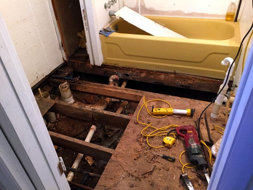 Bathroom floor being pulled apart to reveal mold in crawl spaces