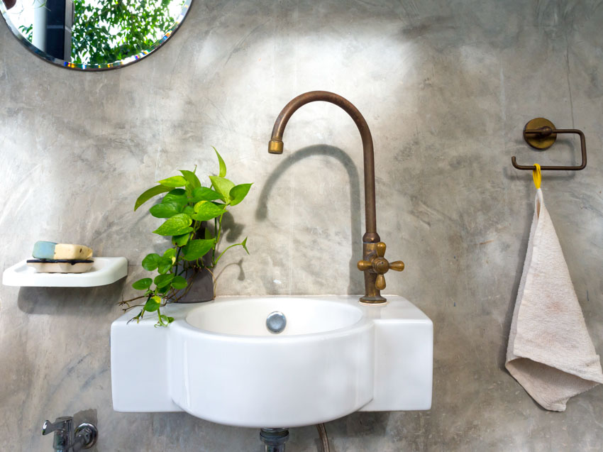 Brass faucet and concrete wall
