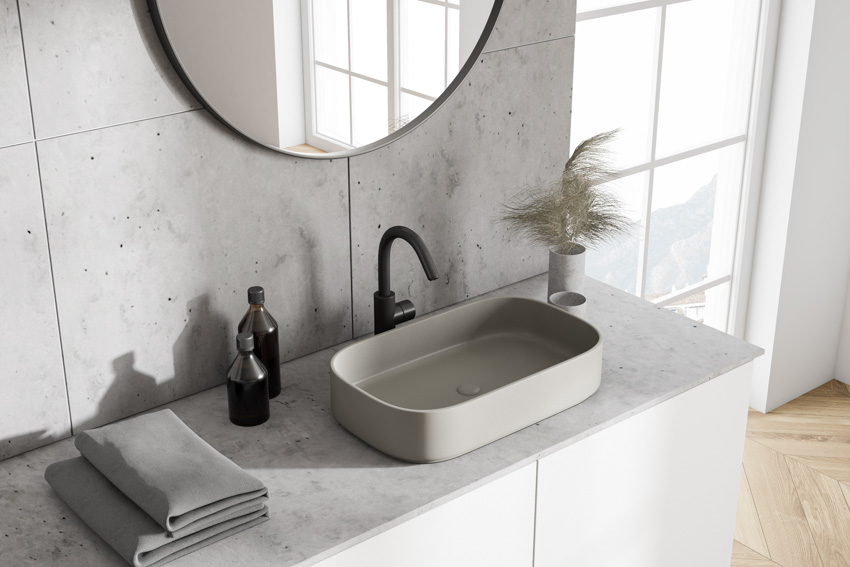 Black colored faucet and gray sink