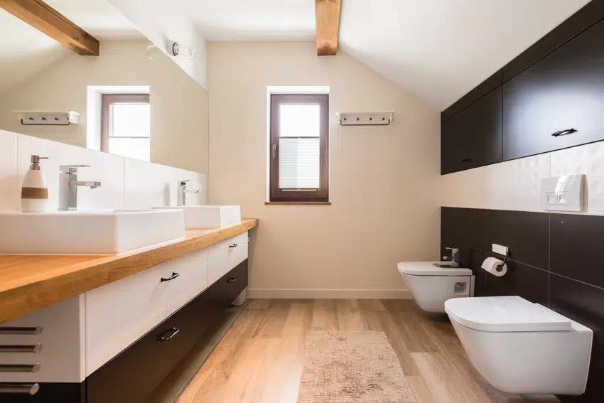 https://designingidea.com/wp-content/uploads/2022/04/bathroom-with-butcher-block-countertop-wood-floor-window-toilet-bidet-mirror-and-drawers-is.jpg.webp