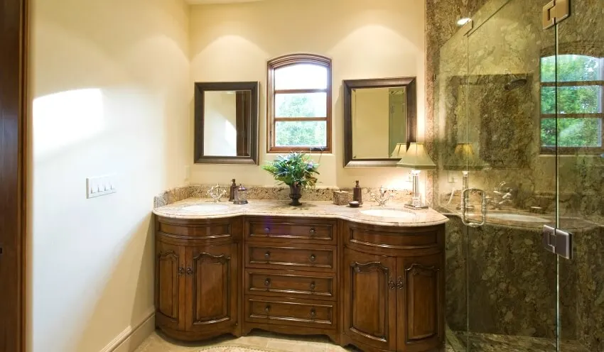 Bathroom with dark color vanity cabinet, beige walls, and granite shower room